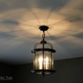 Spray painting a lantern light fixture from the Restore